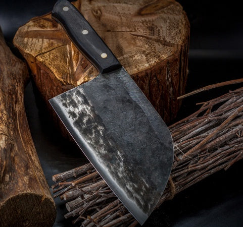 Decorative knife with a textured blade on a wooden stump