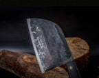 Traditional cleaver knife on a wooden block with a dark background